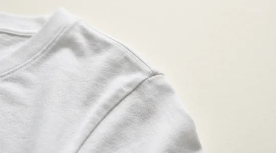 Close-up of a crisp white cotton t-shirt with impeccable tailoring and texture detail showcasing luxury basics styling
