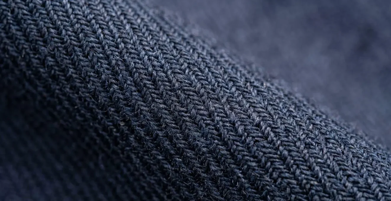 An extreme close-up macro photograph revealing the textural differences between high-quality and low-quality fabric construction