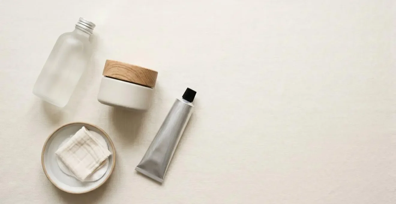Minimalist flat-lay composition showing essential barrier-repair skincare in clean, unbranded containers