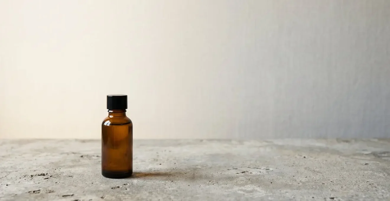 Wide environmental shot of single essential beauty product in vast negative space symbolizing skinimalism and mindful consumption