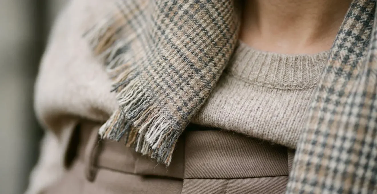A close-up detail of a patterned scarf elegantly bridging two different tonal shades in a monochromatic outfit